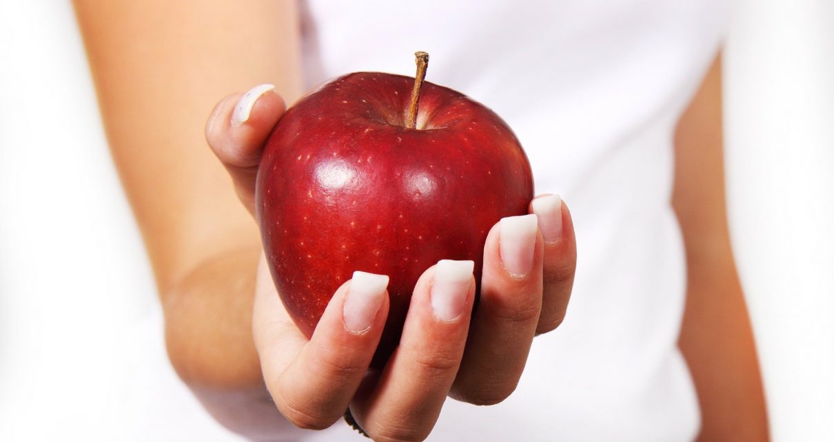 Kobieta z jablkiem chce zrzucić zbęde kilogramy